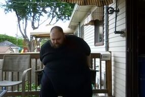 Fat men sitting outside happy
