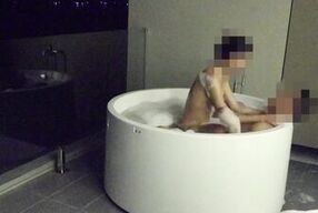 Asian couple having sex in an outdoor jacuzzi, someone is peeking.