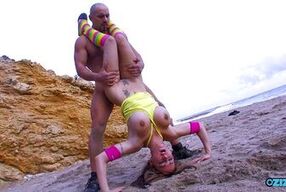 A masculine yoga instructor loves to fuck his horny female girls on a sandy beach